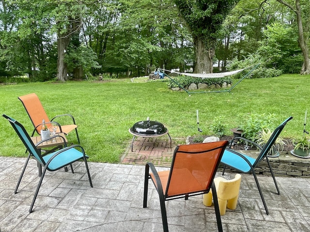 39 Mariner Cir, Trumbull, CT 06611 - view of green lawn with a patio area, view of wooded area, and a fire pit