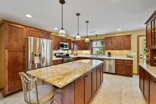 12 Haas Rd, Somers, CT 06071 - kitchen featuring appliances with stainless steel finishes, hanging light fixtures, a kitchen island, light stone countertops, and recessed lighting