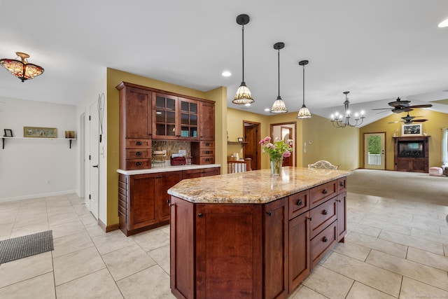 12 Haas Rd, Somers, CT 06071 - kitchen with ceiling fan, light tile patterned floors, open floor plan, hanging light fixtures, and glass insert cabinets