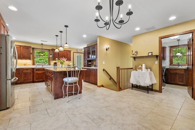 12 Haas Rd, Somers, CT 06071 - kitchen with freestanding refrigerator, a kitchen bar, a kitchen island, recessed lighting, and glass insert cabinets