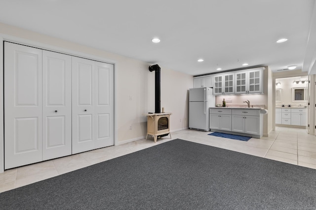 12 Haas Rd, Somers, CT 06071 - unfurnished living room featuring light tile patterned flooring, a wood stove, and recessed lighting