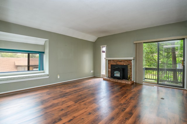 65 Heritage Vlg Unit B, Southbury, CT 06488 - unfurnished living room featuring lofted ceiling, wood finished floors, and a fireplace