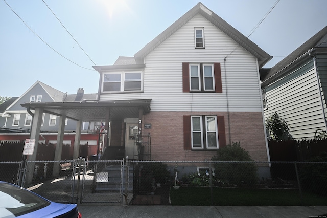 90 Olive St, Bridgeport, CT 06605 - view of front of property featuring brick siding, a fenced front yard, and a gate
