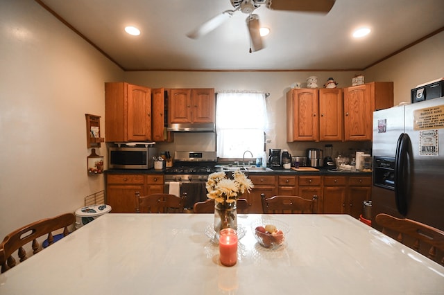 90 Olive St, Bridgeport, CT 06605 - kitchen with appliances with stainless steel finishes, under cabinet range hood, a ceiling fan, brown cabinets, and recessed lighting