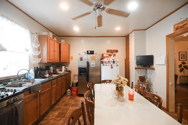 90 Olive St, Bridgeport, CT 06605 - kitchen with appliances with stainless steel finishes, a ceiling fan, brown cabinets, ornamental molding, and recessed lighting