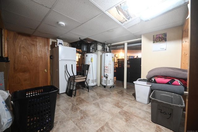 90 Olive St, Bridgeport, CT 06605 - finished below grade area featuring water heater, freestanding refrigerator, and a paneled ceiling