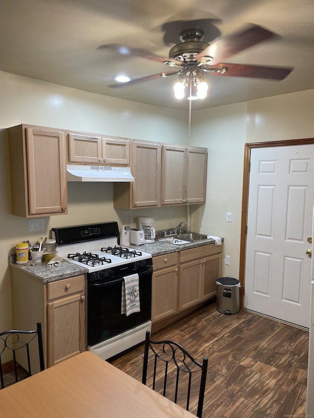 90 Olive St, Bridgeport, CT 06605 - kitchen featuring black gas range oven, under cabinet range hood, dark wood finished floors, and a ceiling fan