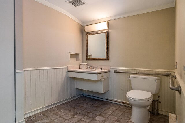 3 Essex Sq, Essex, CT 06426 - bathroom featuring crown molding, wainscoting, vanity, and stone finish floors