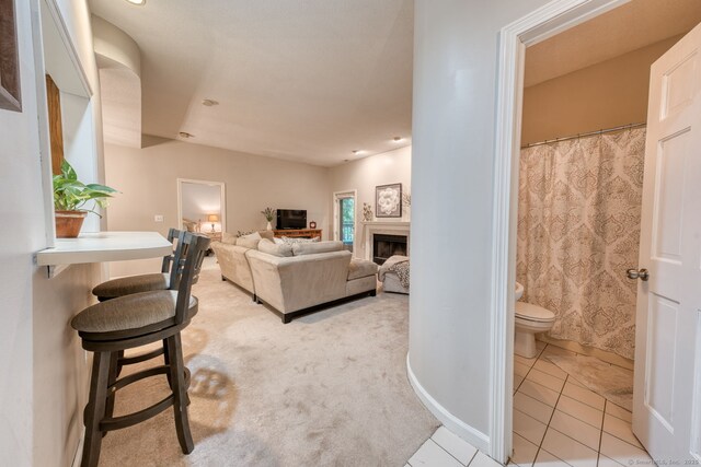 33 Langdon Ct Apt Cl4, Berlin, CT 06037 - living room featuring a fireplace, light colored carpet, and light tile patterned floors