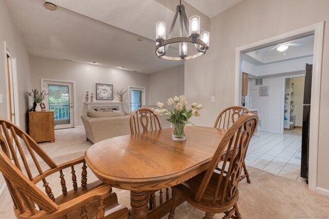 33 Langdon Ct Apt Cl4, Berlin, CT 06037 - dining space with a chandelier, light colored carpet, a ceiling fan, and a fireplace