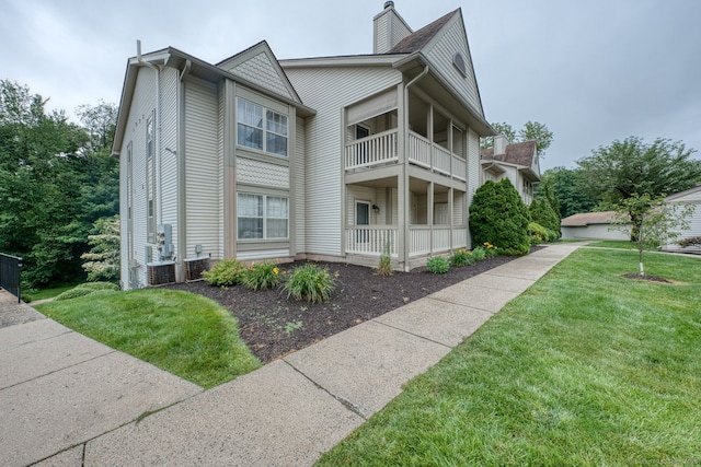 33 Langdon Ct Apt Cl4, Berlin, CT 06037 - view of side of property with a balcony, a lawn, and a chimney