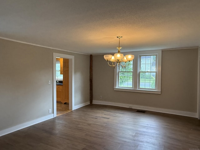 491 Main St, Somers, CT 06071 - empty room featuring a chandelier, wood finished floors, a textured ceiling, and crown molding