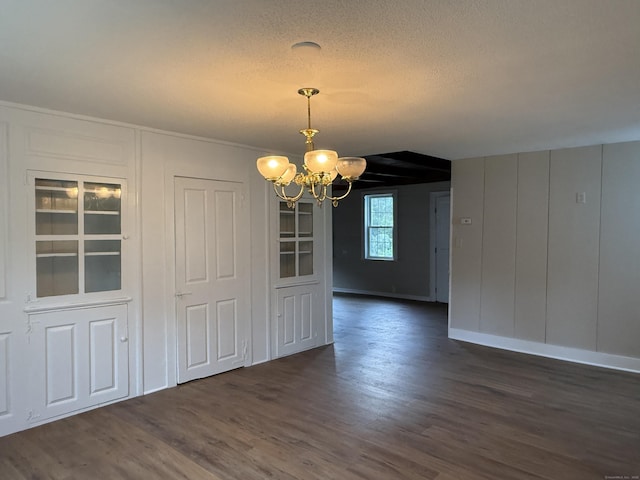 491 Main St, Somers, CT 06071 - unfurnished dining area with a chandelier, dark wood-type flooring, and a textured ceiling