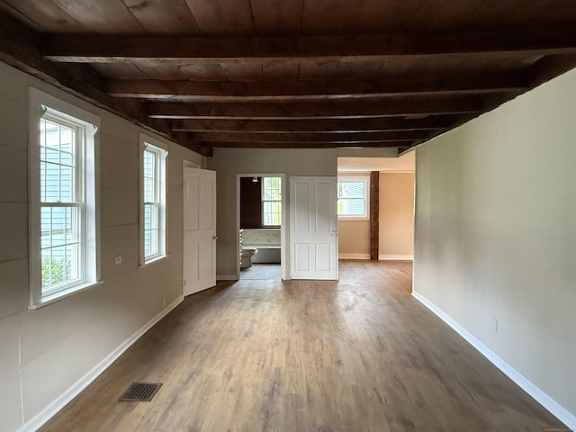491 Main St, Somers, CT 06071 - unfurnished living room with wood finished floors, plenty of natural light, and a wooden ceiling with exposed beams