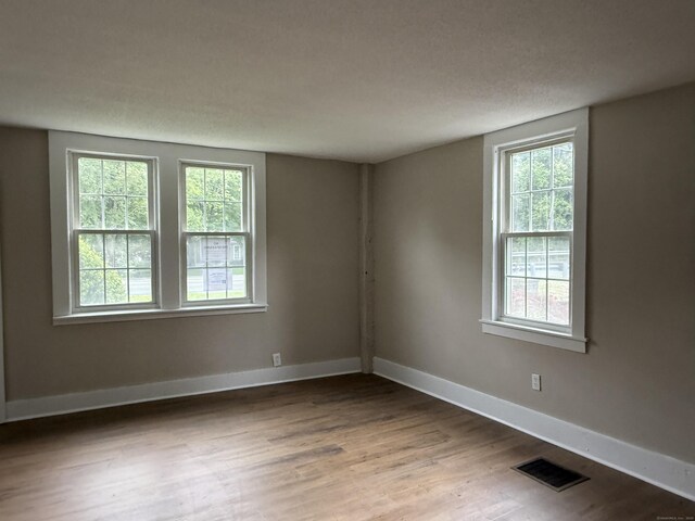 491 Main St, Somers, CT 06071 - unfurnished room with healthy amount of natural light and wood finished floors