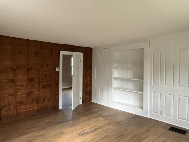 491 Main St, Somers, CT 06071 - unfurnished bedroom featuring wood finished floors, wooden walls, and a closet