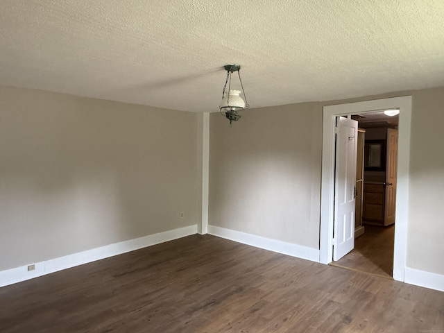491 Main St, Somers, CT 06071 - empty room featuring dark wood-type flooring and a textured ceiling