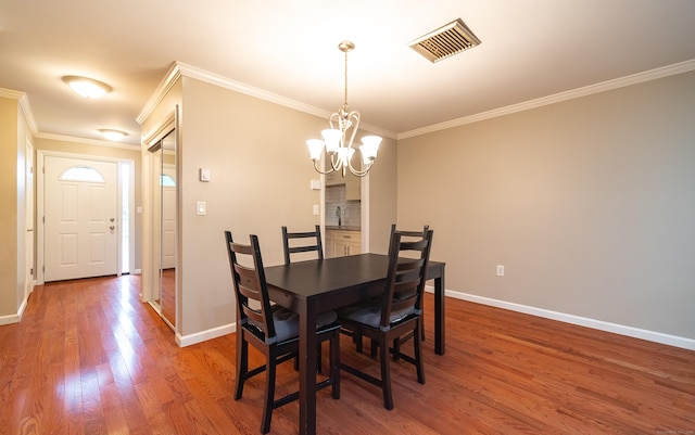 19 Heather Ct Unit 19, Cromwell, CT 06416 - dining area with ornamental molding, wood finished floors, and a chandelier