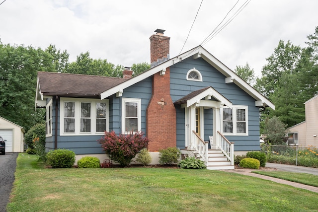 67 Nott St, Wethersfield, CT 06109 - bungalow featuring a chimney, an outdoor structure, a shingled roof, asphalt driveway, and entry steps