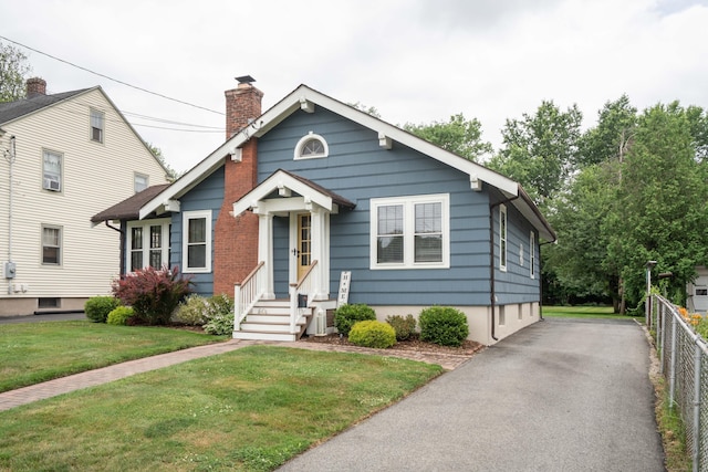67 Nott St, Wethersfield, CT 06109 - bungalow with entry steps, a chimney, and asphalt driveway