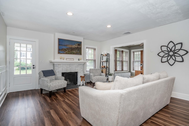 67 Nott St, Wethersfield, CT 06109 - living room with plenty of natural light, a brick fireplace, dark wood finished floors, and recessed lighting