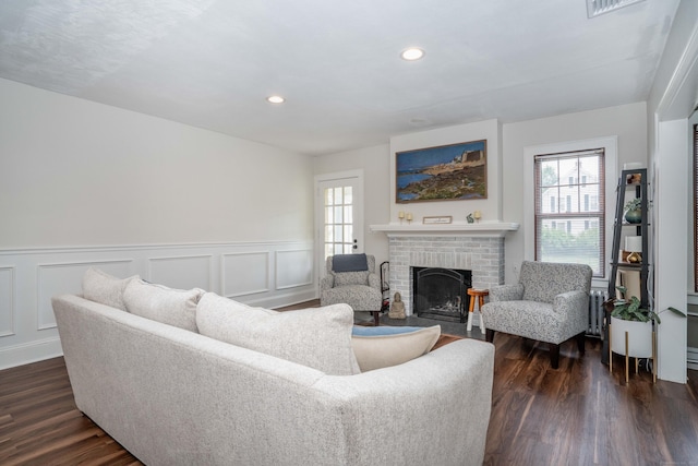 67 Nott St, Wethersfield, CT 06109 - living room with healthy amount of natural light, a fireplace, a wainscoted wall, dark wood-style floors, and recessed lighting