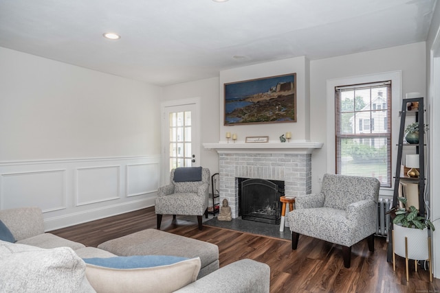 67 Nott St, Wethersfield, CT 06109 - living room featuring wood finished floors, a fireplace, a wainscoted wall, recessed lighting, and a decorative wall