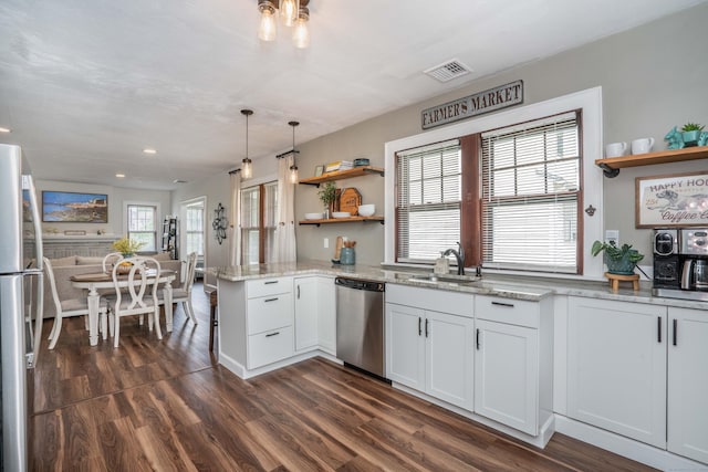 67 Nott St, Wethersfield, CT 06109 - kitchen featuring appliances with stainless steel finishes, open shelves, dark wood-style flooring, white cabinetry, and light stone countertops