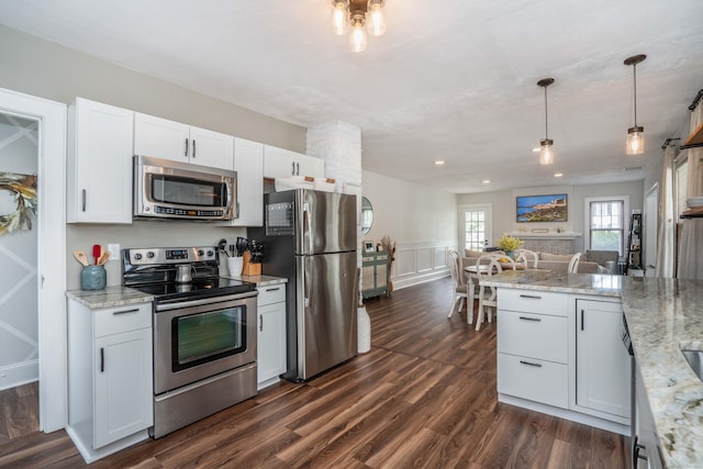 67 Nott St, Wethersfield, CT 06109 - kitchen featuring stainless steel appliances, white cabinets, dark wood-type flooring, light stone countertops, and hanging light fixtures