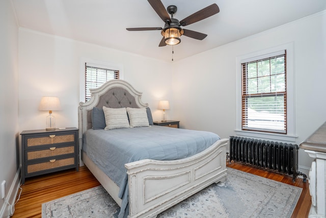 67 Nott St, Wethersfield, CT 06109 - bedroom with radiator, multiple windows, wood finished floors, crown molding, and ceiling fan