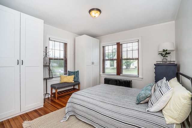 67 Nott St, Wethersfield, CT 06109 - bedroom featuring radiator, wood finished floors, and crown molding