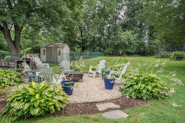 67 Nott St, Wethersfield, CT 06109 - fenced backyard with a fire pit, a storage shed, and view of scattered trees