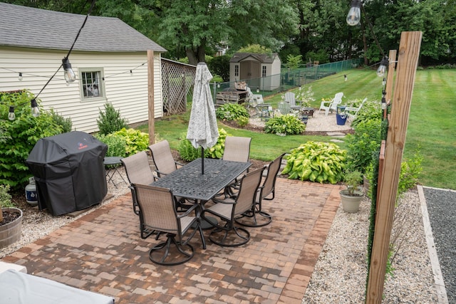 67 Nott St, Wethersfield, CT 06109 - view of patio with a fire pit, grilling area, outdoor dining space, and a storage unit