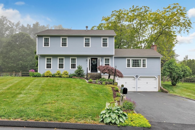 31 Stable Ridge Rd, Monroe, CT 06468 - colonial house with a chimney, an attached garage, and asphalt driveway