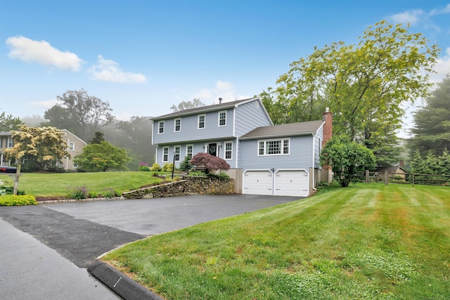 31 Stable Ridge Rd, Monroe, CT 06468 - colonial home with a chimney, asphalt driveway, and a garage