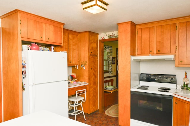 110 Woodfield Rd, Bristol, CT 06010 - kitchen featuring freestanding refrigerator, range with electric cooktop, under cabinet range hood, light countertops, and brown cabinets