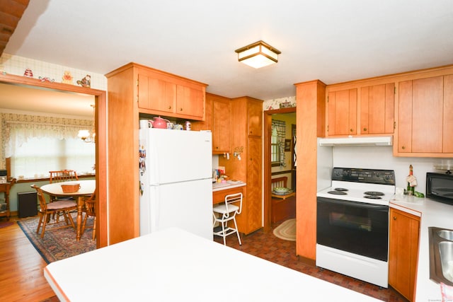 110 Woodfield Rd, Bristol, CT 06010 - kitchen with freestanding refrigerator, range with electric stovetop, under cabinet range hood, light countertops, and dark wood finished floors
