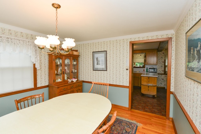 110 Woodfield Rd, Bristol, CT 06010 - dining area with wood finished floors, a chandelier, wallpapered walls, and crown molding