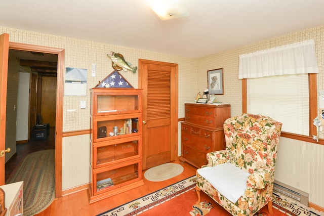 110 Woodfield Rd, Bristol, CT 06010 - sitting room featuring wood finished floors, wallpapered walls, and a wood stove