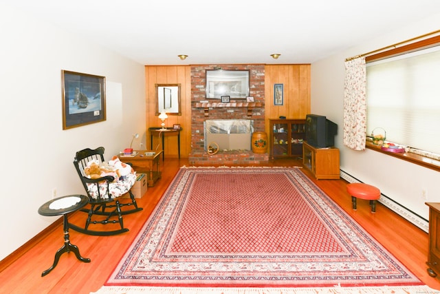 110 Woodfield Rd, Bristol, CT 06010 - living room with wood finished floors, a baseboard heating unit, and wood walls