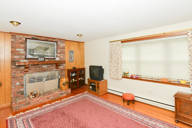 110 Woodfield Rd, Bristol, CT 06010 - living area featuring wood finished floors, a fireplace, and a baseboard radiator