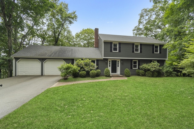 109 Hemlock Dr, Killingworth, CT 06419 - colonial-style house featuring a chimney, asphalt driveway, an attached garage, a front yard, and a shingled roof