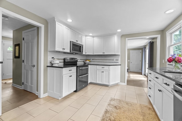 109 Hemlock Dr, Killingworth, CT 06419 - kitchen with appliances with stainless steel finishes, backsplash, white cabinets, recessed lighting, and light tile patterned flooring