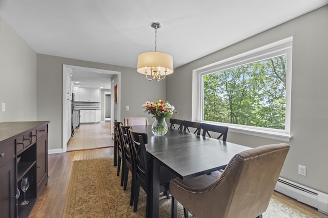 109 Hemlock Dr, Killingworth, CT 06419 - dining room featuring baseboard heating, a chandelier, and wood finished floors