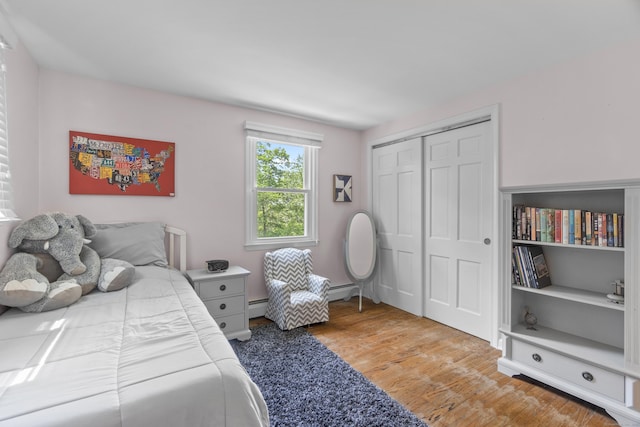 109 Hemlock Dr, Killingworth, CT 06419 - bedroom with wood finished floors, a baseboard radiator, and a closet