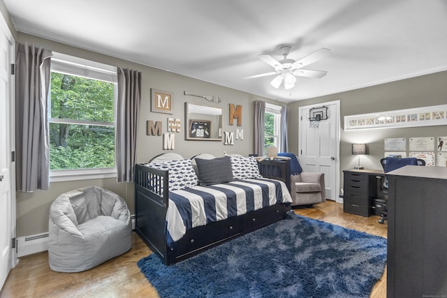 109 Hemlock Dr, Killingworth, CT 06419 - bedroom featuring a baseboard heating unit, multiple windows, and wood finished floors