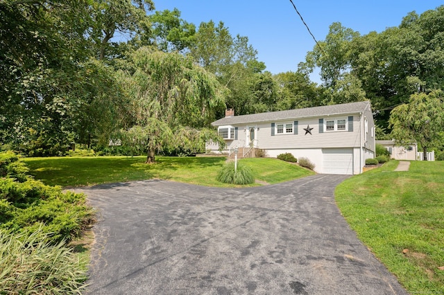 43 Dimmock Rd, Waterford, CT 06385 - ranch-style home featuring asphalt driveway, a garage, a chimney, and a front lawn