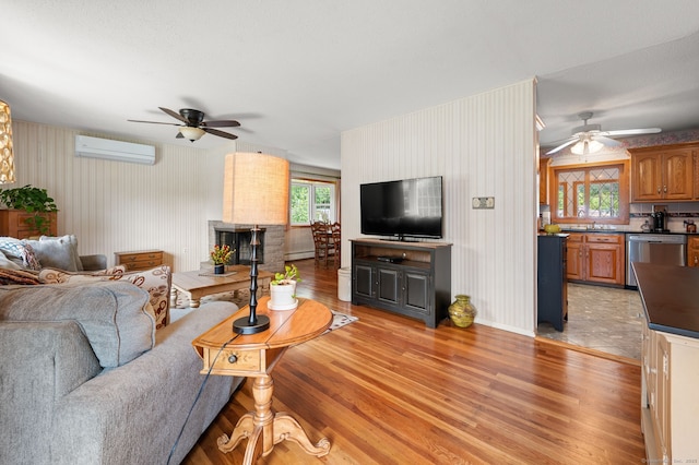 43 Dimmock Rd, Waterford, CT 06385 - living area featuring a ceiling fan, a wall mounted AC, light wood-type flooring, and a baseboard heating unit