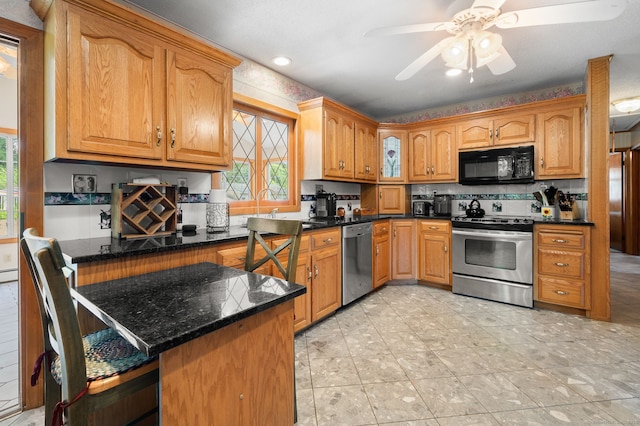 43 Dimmock Rd, Waterford, CT 06385 - kitchen with appliances with stainless steel finishes, plenty of natural light, a ceiling fan, and a peninsula