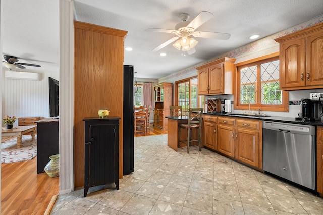 43 Dimmock Rd, Waterford, CT 06385 - kitchen with dishwasher, ceiling fan, a wall unit AC, dark countertops, and brown cabinetry